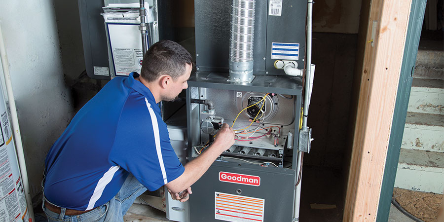 Service technician testing heating system
